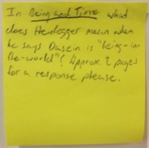 In Being and Time what does Heiddeger mean when he says Dasein is "being-in-the-world" ? Approx 2 pages for a response please