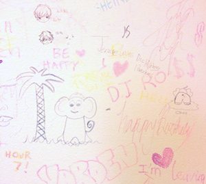 Express Yo'self Wall at Brandeis: [drawing of palm tree and monkey] Be Happy, DJ Ross, Hour 7! [small cartoon faces]
