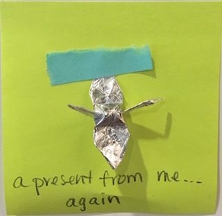 a present from me... again [foil origami crane taped to post-it]