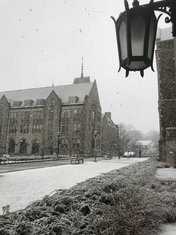 photo of Boston College in light snow, with lamp in foreground