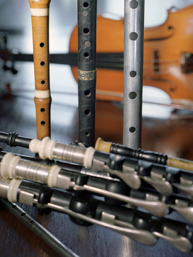 Photograph of Uilleann pipe drones, tin whistles, fiddles, and other instruments