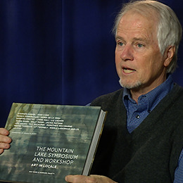 Professor Alston Conley holding a book