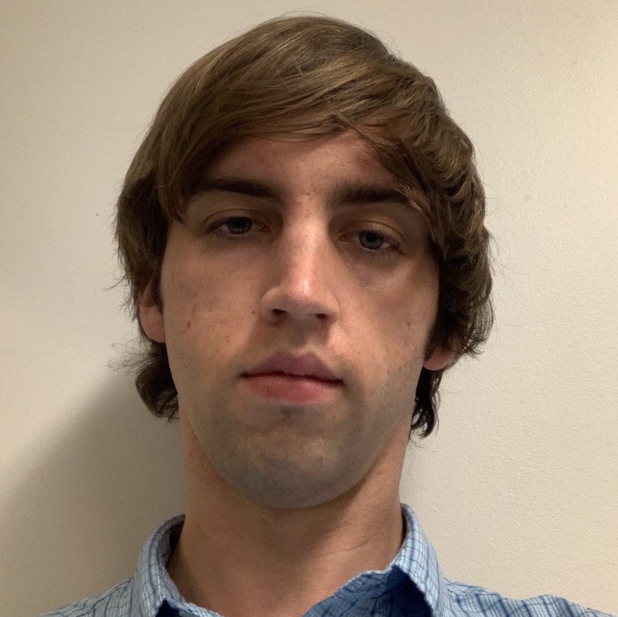 color photo of a person with light brown hair, in a blue checked shirt