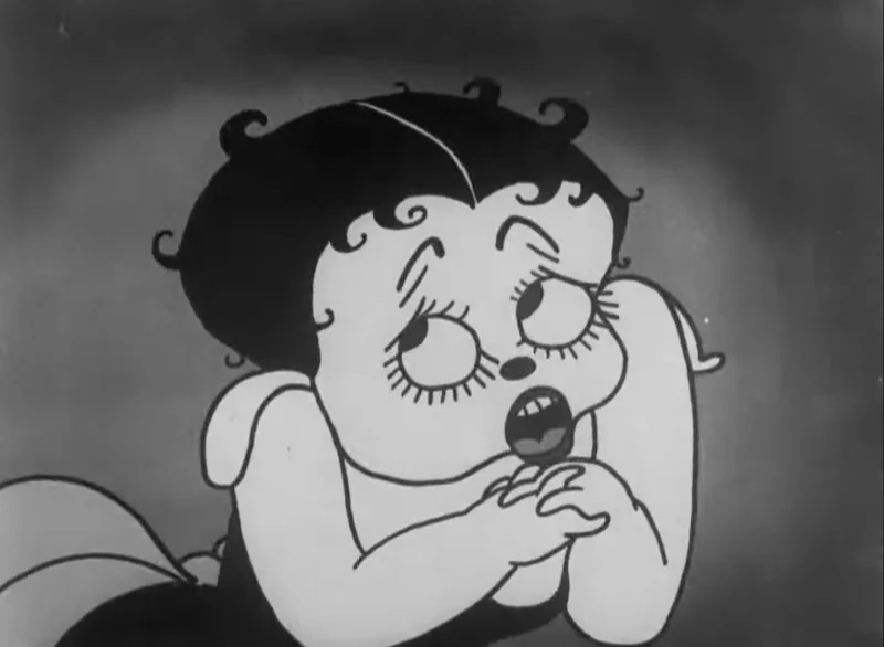 black and white cartoon character woman drawn with curls of black hair, large round eyes with accentuated eyelashes, and a low cut dress